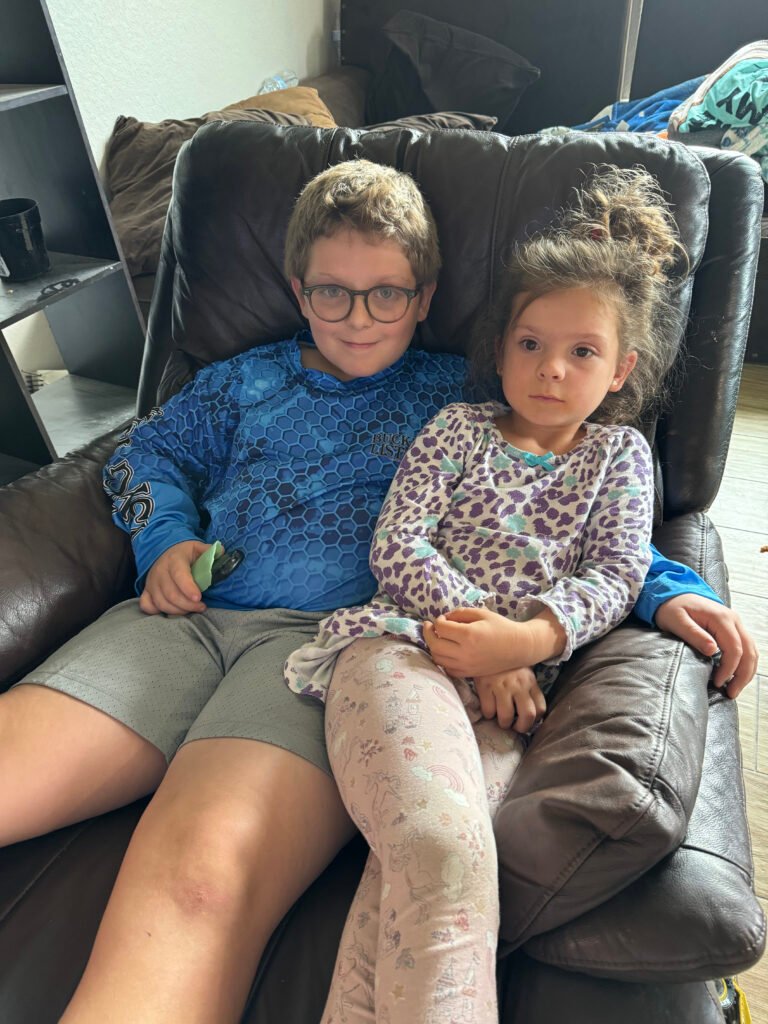 Lee kids sitting in lounge chair -homemaking